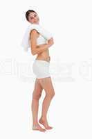 Side view of a slim woman holding a towel