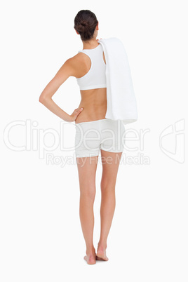 Rear view of a slim woman holding a towel