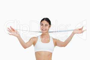 Smiling slim woman with a measure tape