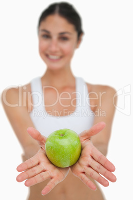 Close-up a green apple holding by a brunette