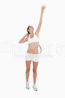 Slim woman playing tennis in white clothes