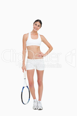 Slim brunette posing with a tennis racket