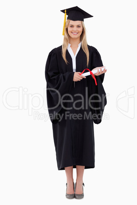 Smiling blonde student in graduate robe holding her diploma