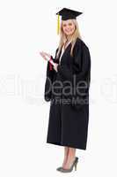 Blonde student in graduate robe holding a diploma