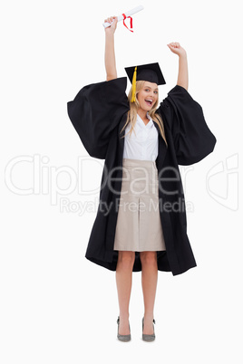 Blonde student in graduate robe holding up her diploma