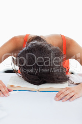 Depressed student head on her books