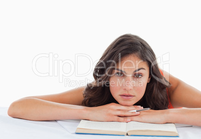 Frowning student head on her books