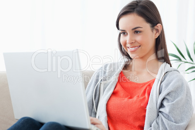 A woman with a lovely smilw using her laptop