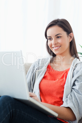 A close up shot of a woman using her laptop