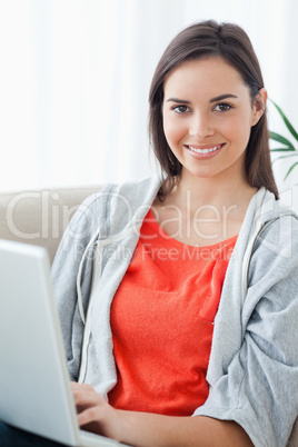 Close up of a woman using her laptop and looking into the camera