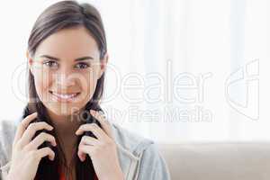 Head and shoulder shot of a woman smiling and looking into the c