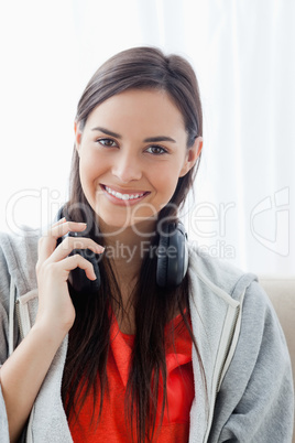 Close up shot of a woman with headphones looking into the camera