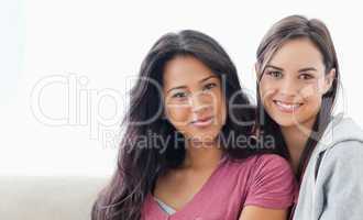 Head and shoulder shot of two women lying against each other whi