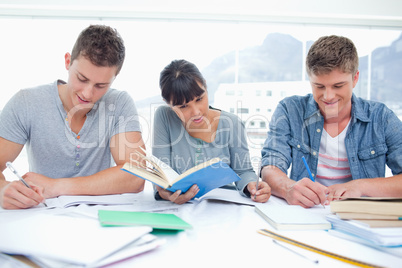 Three students study hard together