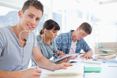 Side view of a group of students as one student looks at the cam