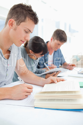 Close up of three students studying hard