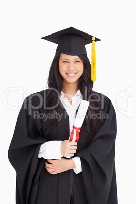 Woman with her degree dressed in her graduation gown