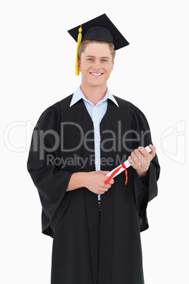 Man smiling as he has just graduated with his degree