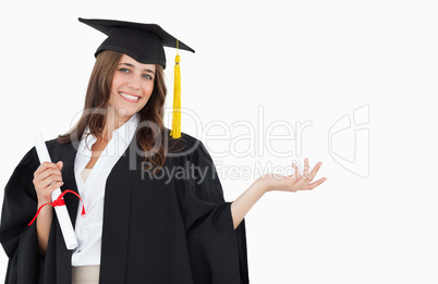 A woman with a hand out to her side as she smiles and looks at t