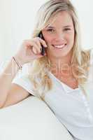 Close up of a woman smiling as she talks on the phone
