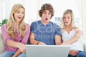 Shocked siblings at what is on the laptop