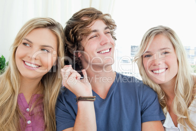 Three friends listening to a phone conversation