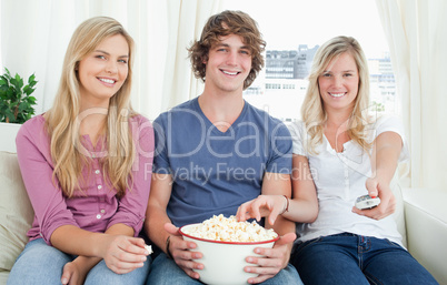 Three friends enjoying popcorn together