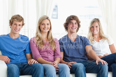 A group of people sitting together on the couch