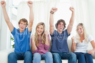 A group of friends celebrate together while looking at the camer