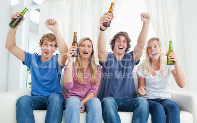 Cheering group of friends looking at the camera