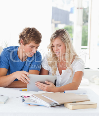 A couple look at a tablet together