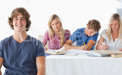 A young man sitting in front of his working class mates