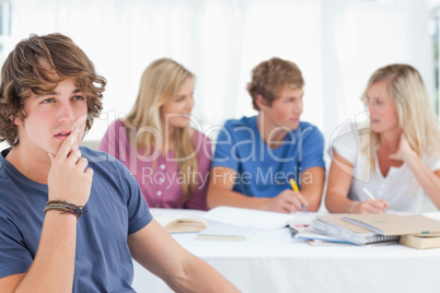 Close up of a thinking man sitting in front of his friends