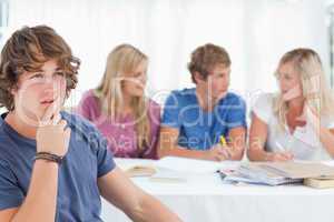 Close up of a thinking man sitting in front of his friends