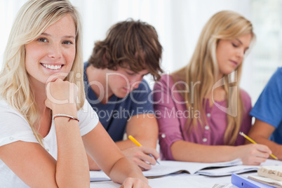 Close up of a smiling girl with her friends as she looks at the