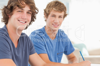 Two male students looking into the camera and smiling