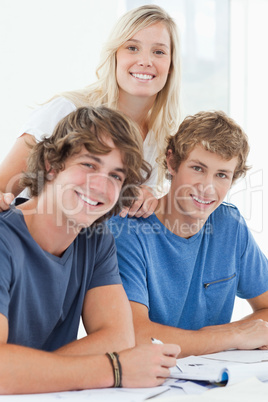 Three smiling students as they look at the camera