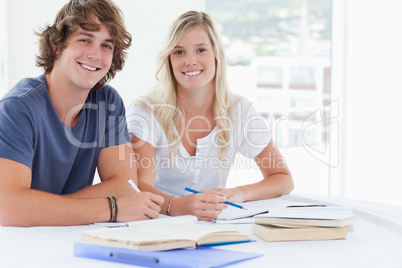 Smiling couple of students looking at the camera