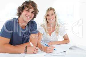 A smiling group of people as they both look at the camera