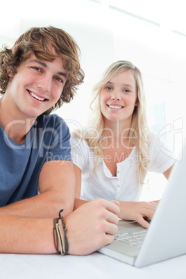 Close up of a smiling couple looking at the camera