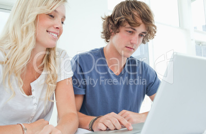 A couple surfing the web on a laptop