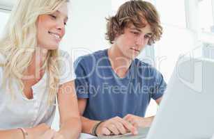 A couple surfing the web on a laptop