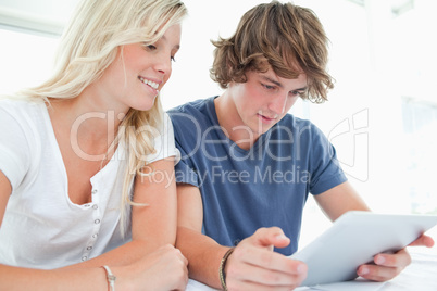 A couple surfing on a tablet