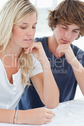 Close up of a worried couple waiting for a pregnancy test result