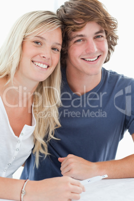 A smiling couple holding a pregnancy test