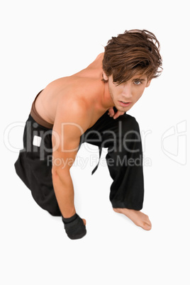 Martial arts fighter kneeling down