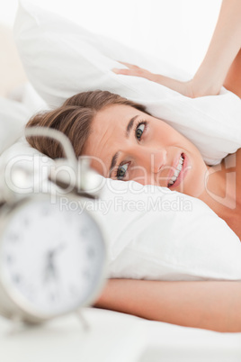 Close up of woman with pillow over her ears