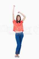 Casual teenager raising her arms above her head