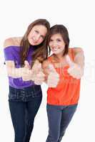 Teenagers putting their thumbs up while smiling