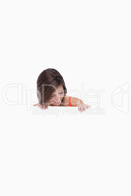 Teenage girl leaning her head forward while looking at a blank p